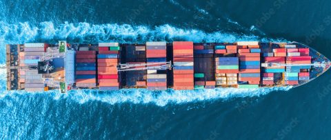 Aerial view of container ship at sea, showing how Gradient supports with USCG compliance solutions