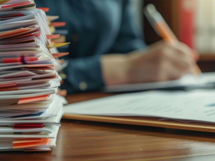 Stack of papers on a desk, showing how Gradient simplifies transportation compliance