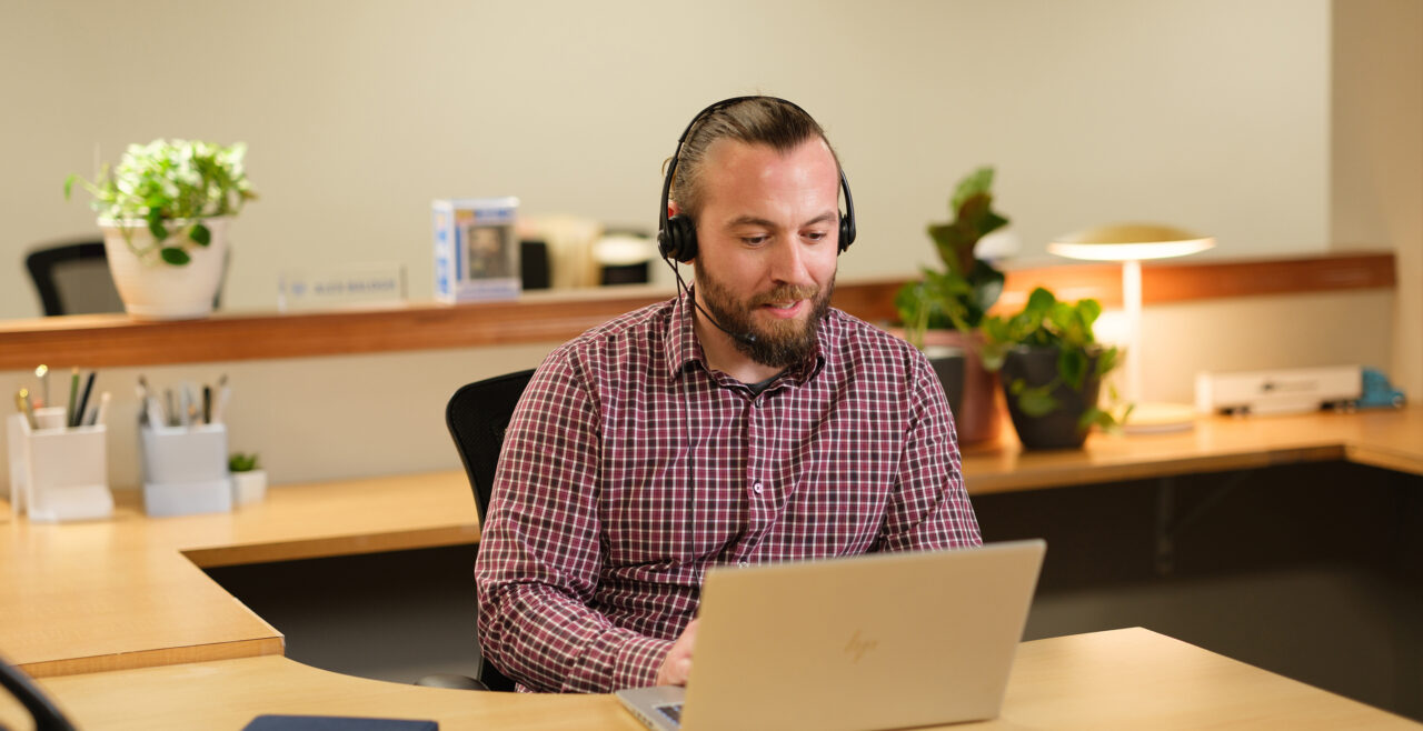 Gradient team member at desk, ready to help with your transportation compliance needs