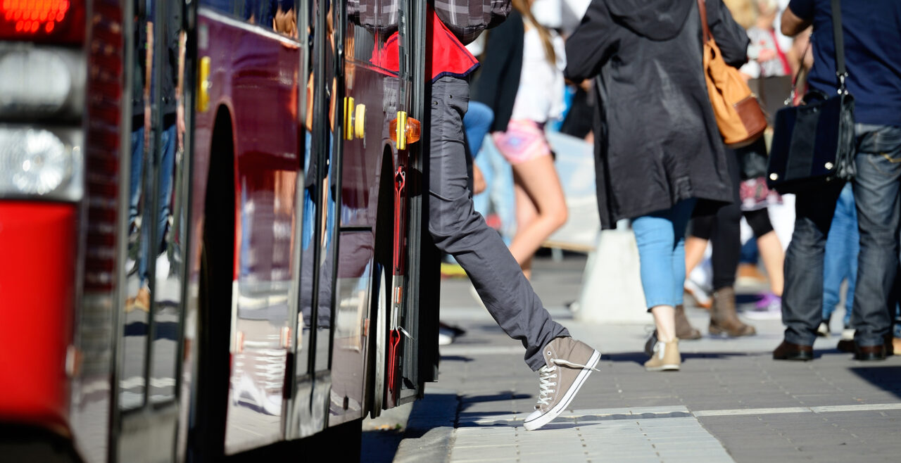 Person entering a city bus, showing how Gradient helps with FTA compliance solutions