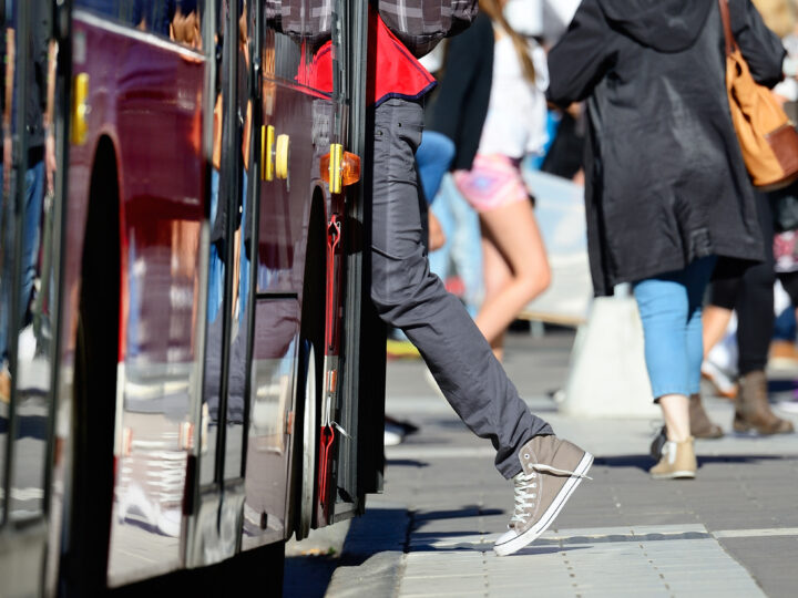 Person entering a city bus, showing how Gradient helps with FTA compliance solutions