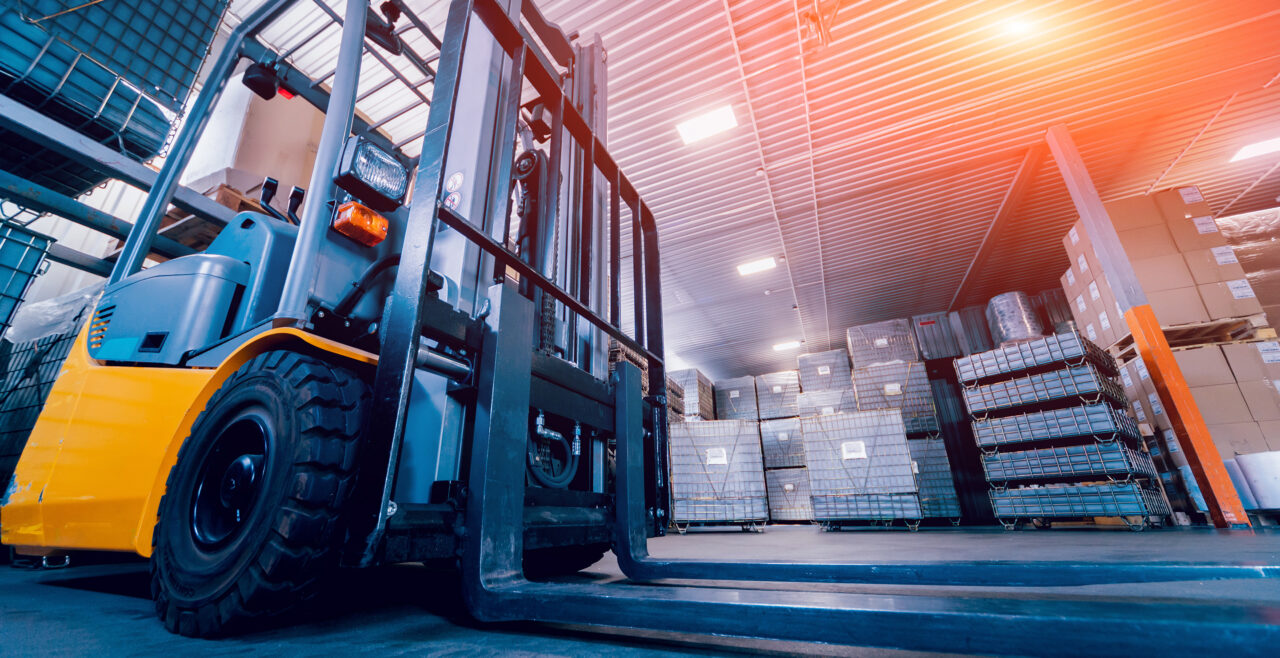 Forklift loader in a warehouse, showing how Gradient supports clients with safety regulations even outside of DOT.