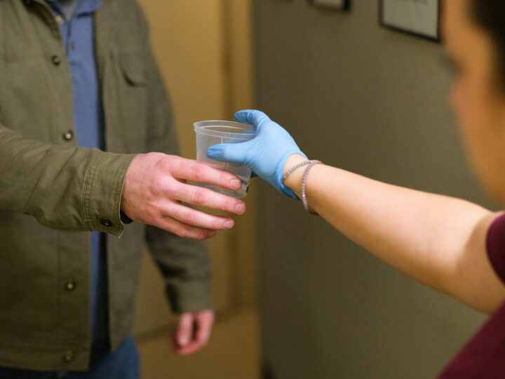 Gradient clinical team member handing a specimen collection for DOT compliance