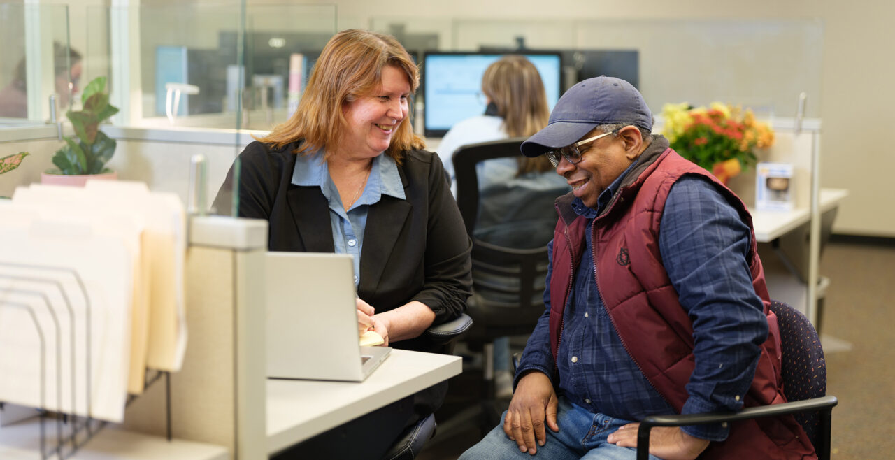 Gradient team member sitting and working with a client, as part of a partnership approach to transportation compliance