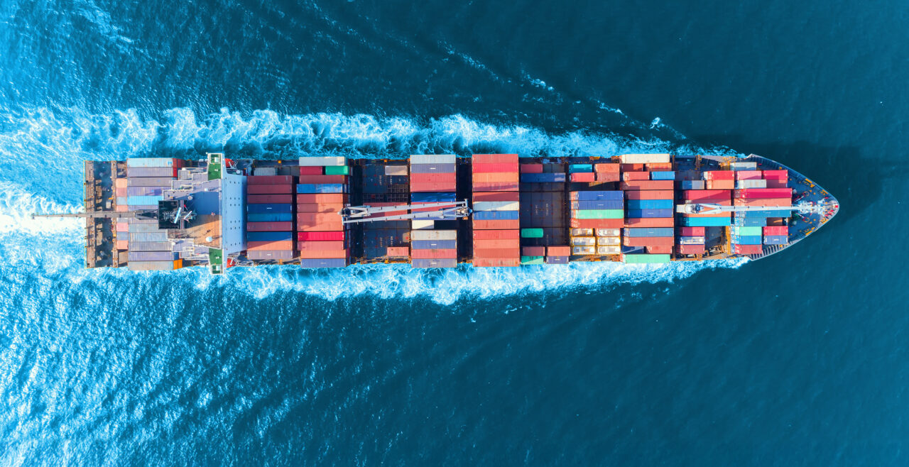 Aerial view of container ship at sea, showing how Gradient supports with USCG compliance solutions